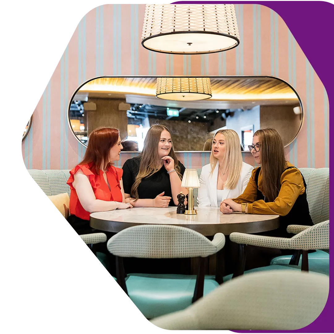 Photo of team sat around a table